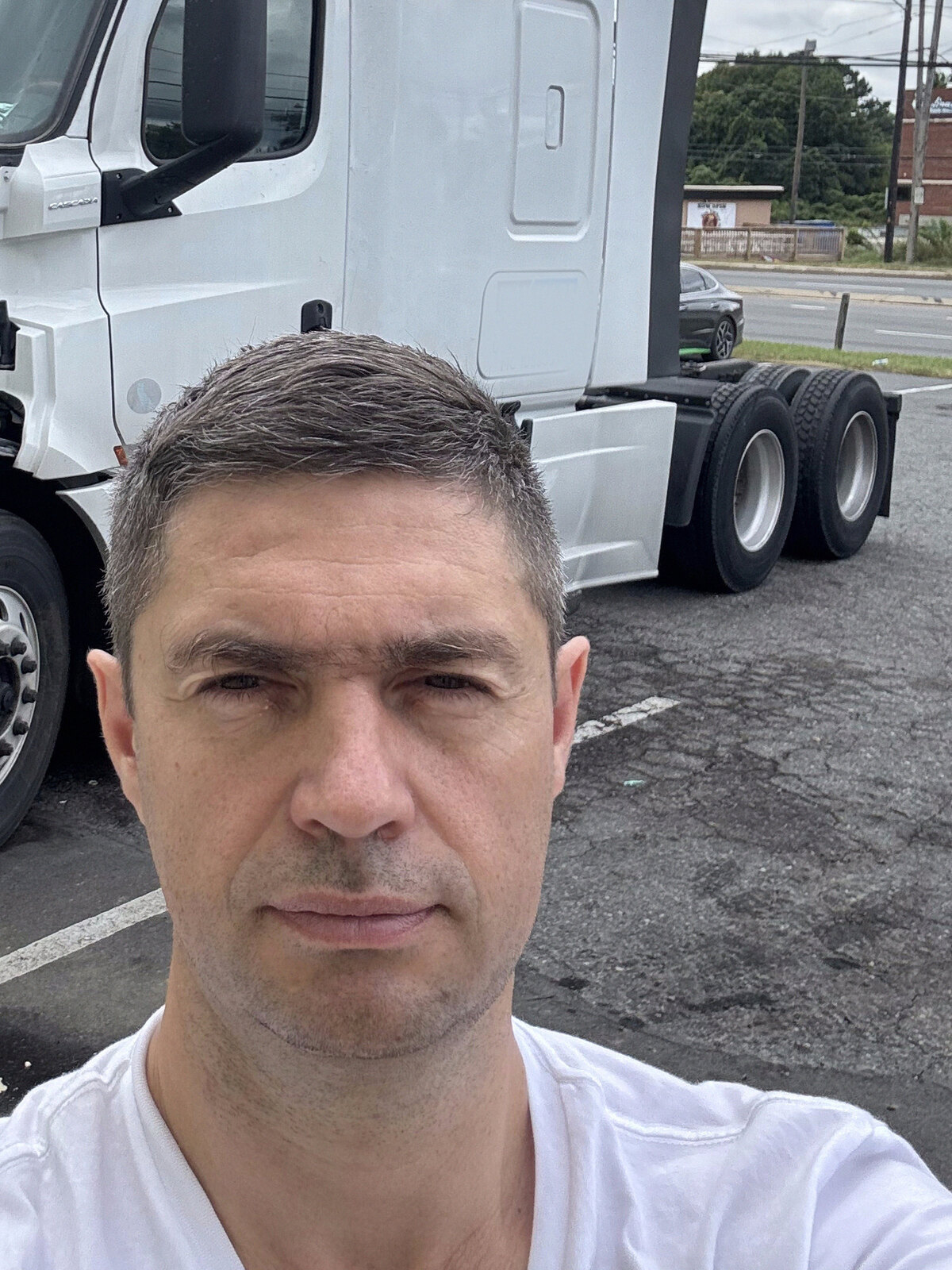 Driver in front of his Freightliner Cascadia